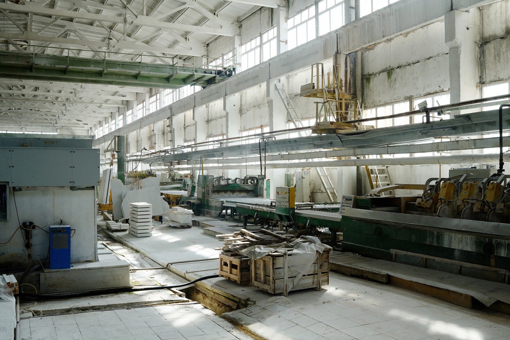 Horizontal image of big workshop of factory for cutting stone with machines and materials